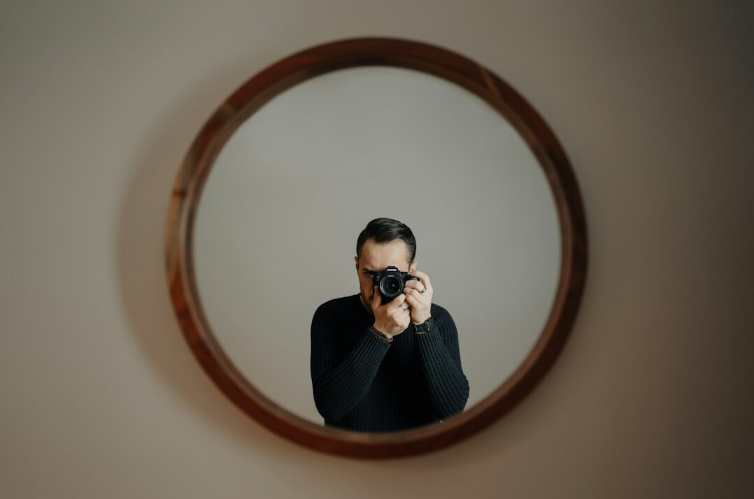 person reflecting in mirror