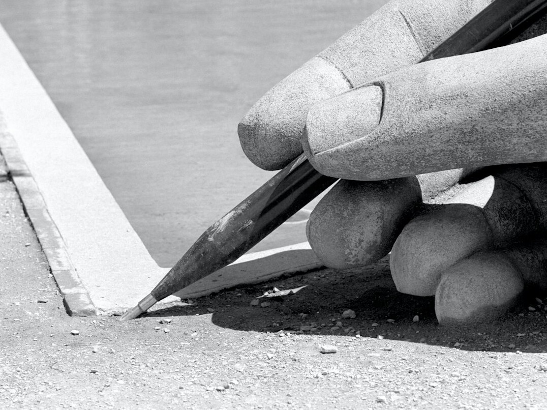 Hand writing in a notebook with a pen