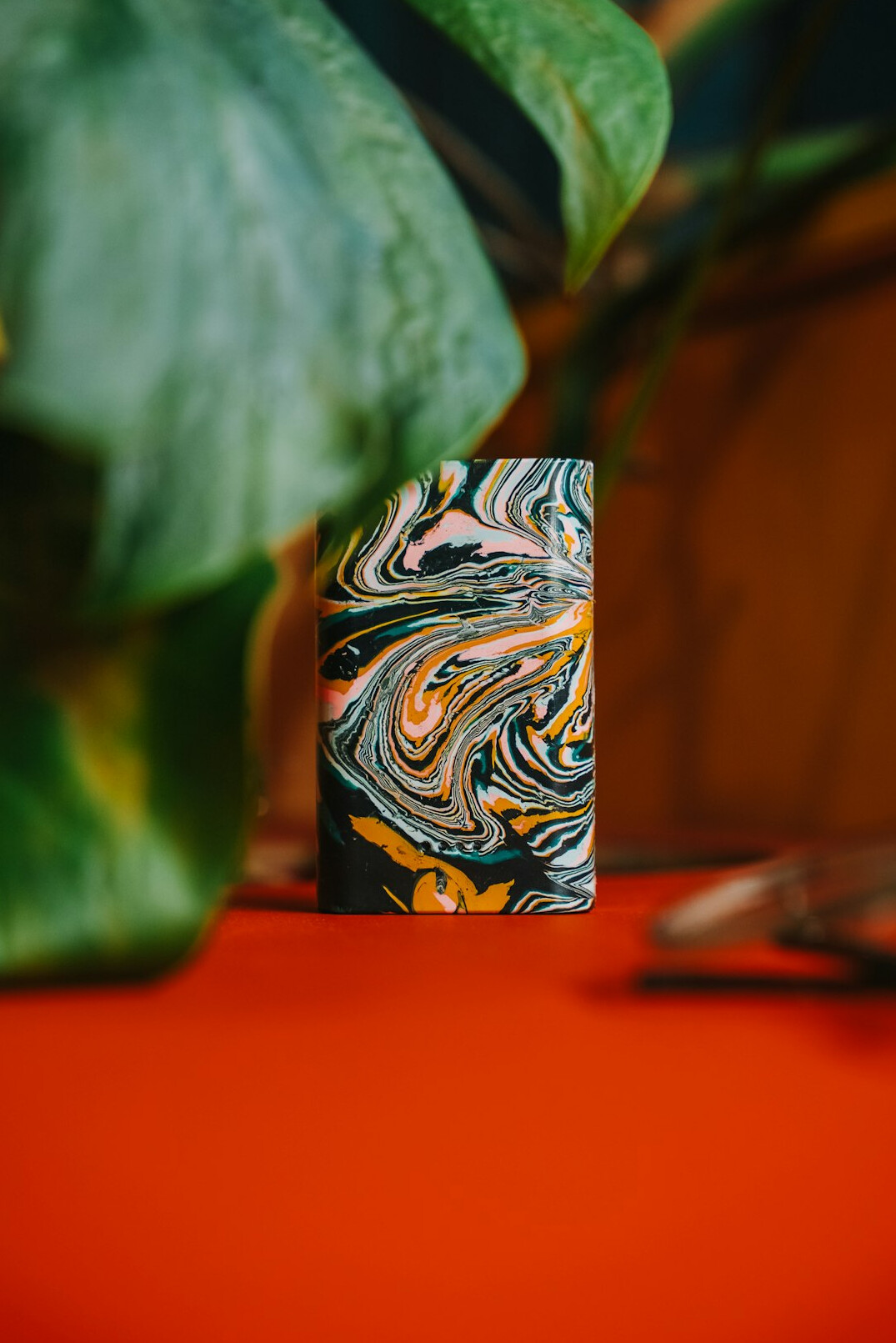 Notebook and pen on a desk with plants