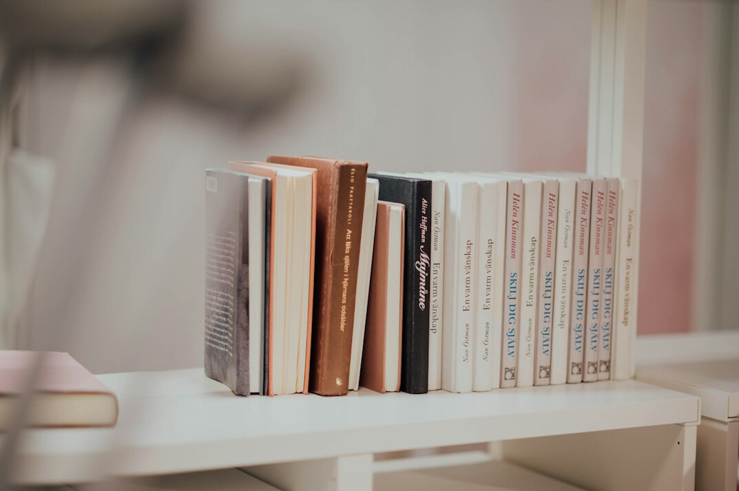 Open books and notebook on a wooden desk